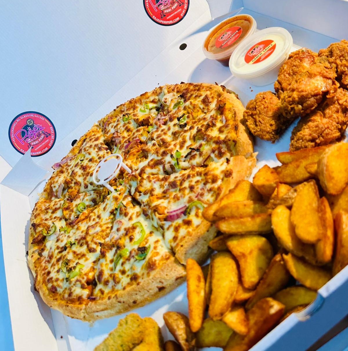 Raja’s Peri Peri box includes pizza, potato wedges, and fried chicken wings in Glasgow.