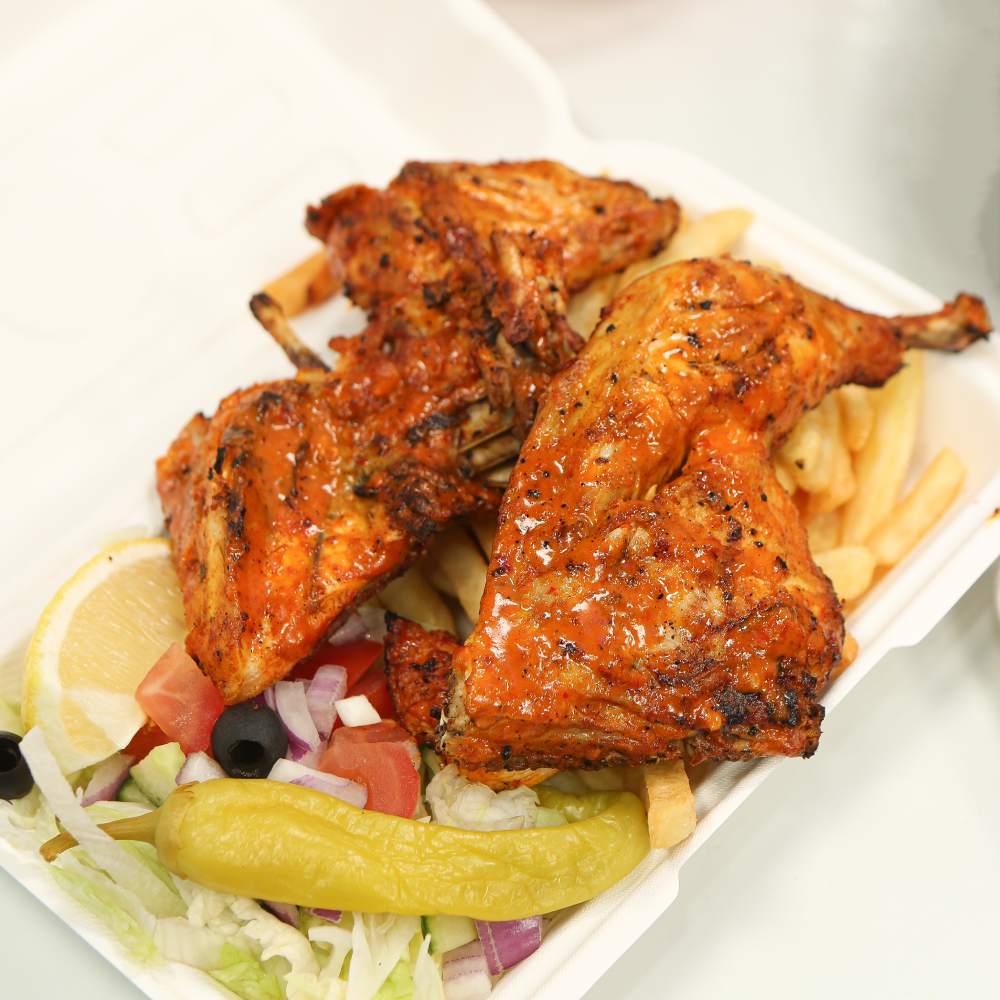 Raja’s Peri Peri flame-grilled Peri Peri chicken pieces served over fries in Glasgow. 